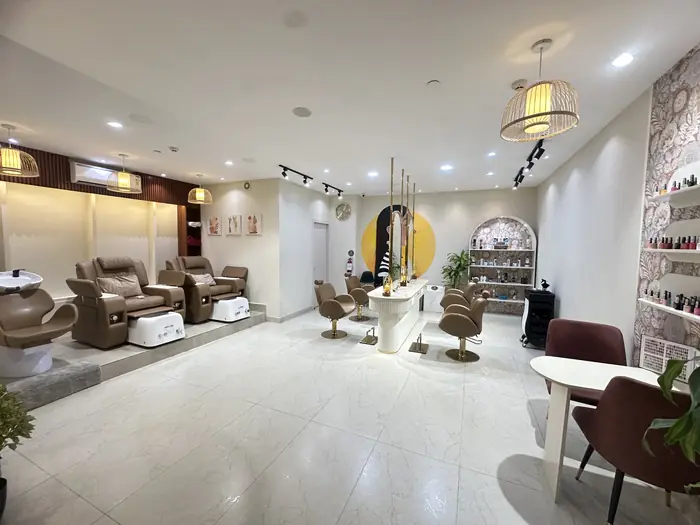 The main salon floor at Citrine, with styling stations and pedicure lounge